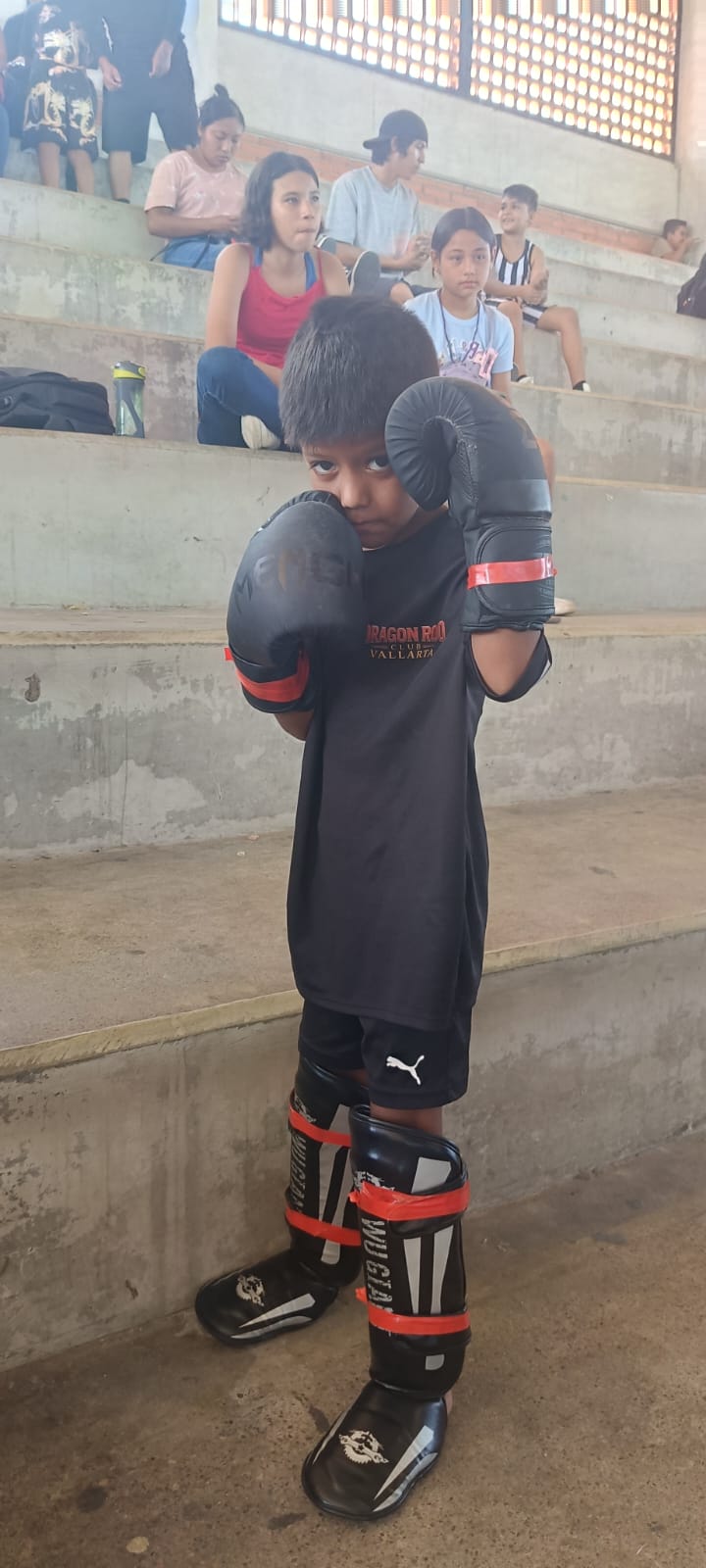 Young martial arts participant wearing protective gear