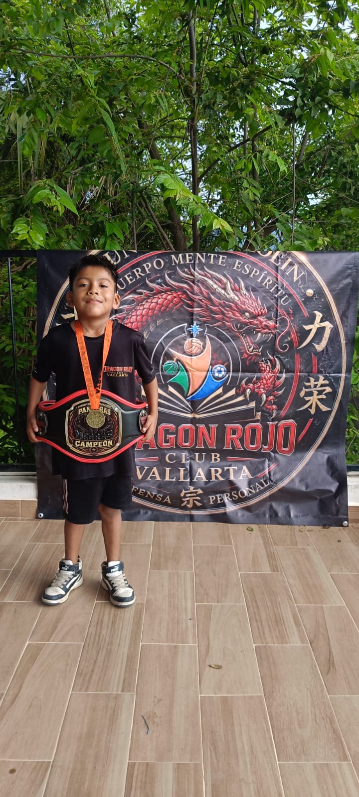Young martial arts participant wearing a medal