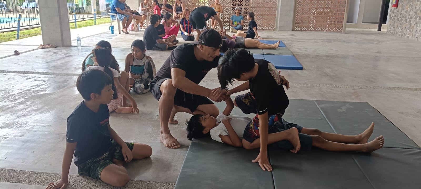 Students practicing exercises on mats