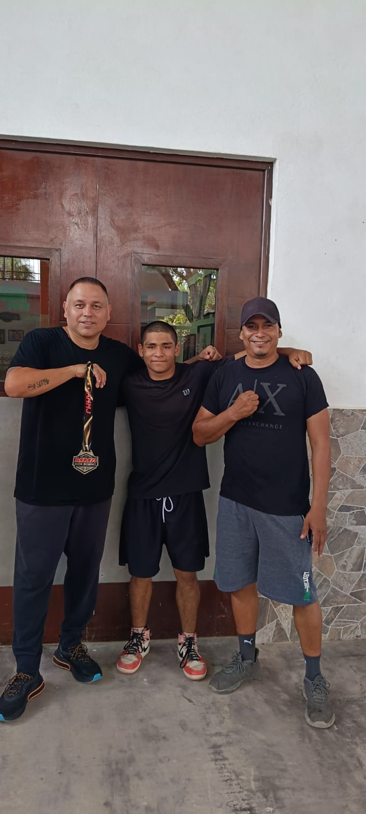 Martial arts participants and instructor posing outdoors